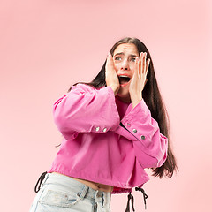 Image showing Portrait of the scared woman on pink