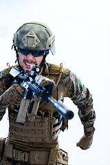 Image showing soldier in action aiming laseer sight optics