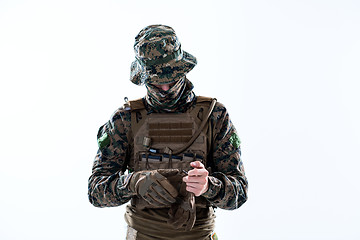 Image showing closeup of soldier hands putting protective battle gloves