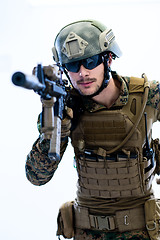 Image showing soldier in action aiming laseer sight optics