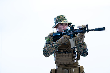 Image showing soldier in action aiming laseer sight optics