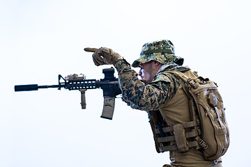 Image showing soldier in action aiming laseer sight optics