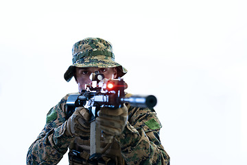 Image showing soldier in action aiming laseer sight optics