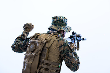 Image showing soldier in action giving comands to team by hand sign