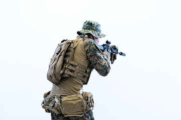 Image showing soldier in action aiming laseer sight optics