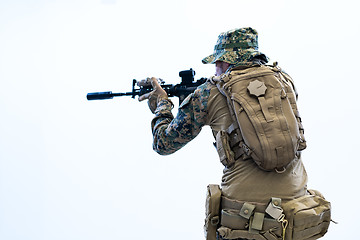 Image showing soldier in action aiming laseer sight optics