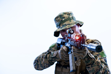 Image showing soldier in action aiming laseer sight optics