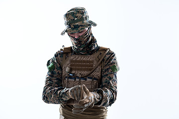 Image showing closeup of soldier hands putting protective battle gloves