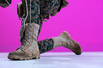 Image showing soldier tying the laces on his boots