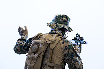 Image showing soldier in action giving comands to team by hand sign