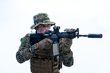 Image showing soldier in action aiming laseer sight optics