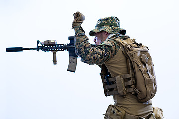 Image showing soldier in action aiming laseer sight optics