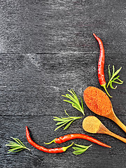 Image showing Frame of different pepper and rosemary on black board top