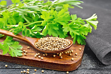 Image showing Coriander seeds in spoon on black board