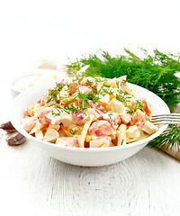 Image showing Salad of surimi and eggs with mayonnaise on wooden table