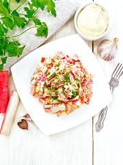 Image showing Salad of surimi and tomatoes with mayonnaise on board top