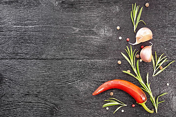 Image showing Frame of pepper and rosemary on black board top