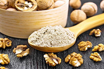 Image showing Flour walnut in spoon on black wooden board