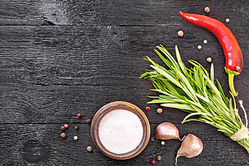 Image showing Frame of salt and rosemary on black board top