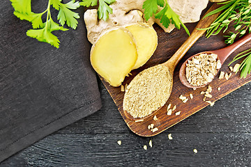 Image showing Ginger ground and flakes in spoons on board top