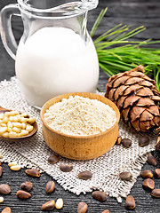 Image showing Flour cedar in bowl with nuts on black board