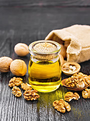 Image showing Oil walnut in jar on wooden board