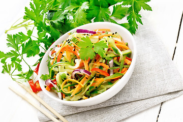 Image showing Salad of cucumber in bowl on light wooden board