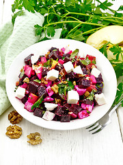 Image showing Salad with beetroot and feta in plate on light board