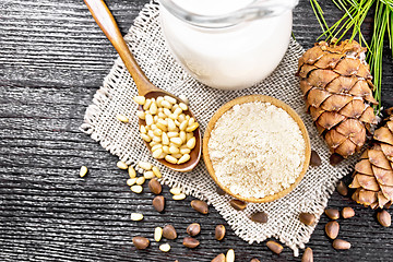 Image showing Flour cedar in bowl with nuts on board top