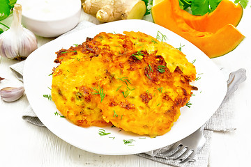 Image showing Pancakes of pumpkin in plate on white wooden board