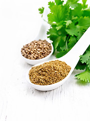 Image showing Coriander ground and seeds in spoons on white board