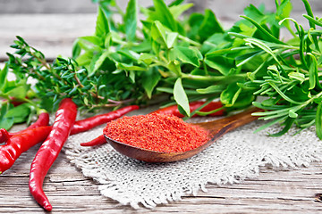 Image showing Peppers red powder in wooden spoon on old board