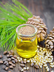 Image showing Oil cedar in glass jar on board