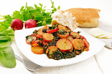 Image showing Radish with spinach and spices in plate on light wooden board