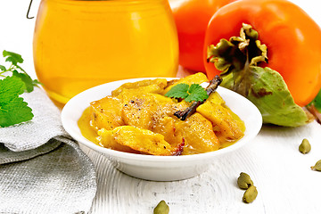 Image showing Persimmons baked with honey in dish on light board