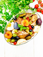 Image showing Chicken with fruits and tomatoes in pan on light board top