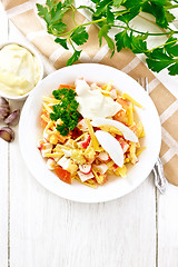 Image showing Salad of surimi and tomatoes with eggs on light board top