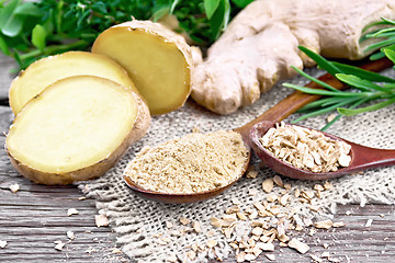 Image showing Ginger ground and flakes in spoons with root on old board