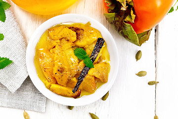 Image showing Persimmons baked with honey in dish on board top