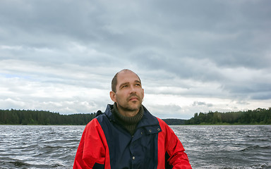 Image showing Mature Man Against A Overcast Landscape With A Lake