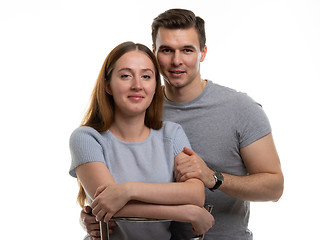 Image showing Portrait of a happy and cheerful young couple, a guy hugs a girl