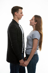 Image showing The guy and the girl are standing in front of each other and have taken their hands