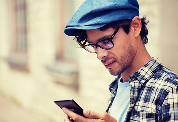 Image showing close up of man texting message on smartphone