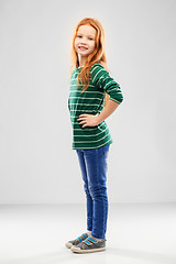 Image showing smiling red haired girl posing in striped shirt