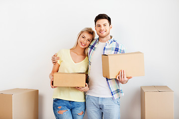 Image showing happy couple with boxes moving to new home