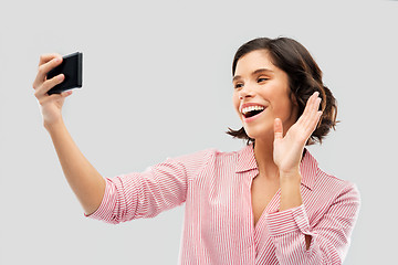 Image showing smiling young woman taking selfie by smartphone