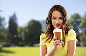 Image showing woman or teenage girl drinks coffee at summer park