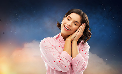 Image showing happy woman in pajama making sleeping gesture