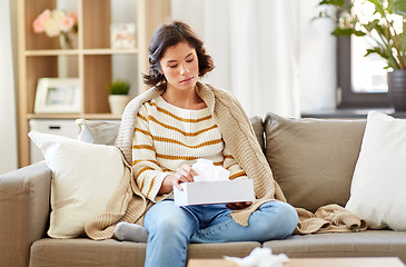 Image showing sick woman taking paper tissue from box at home
