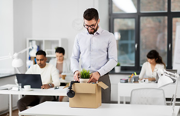 Image showing happy male office worker with personal stuff